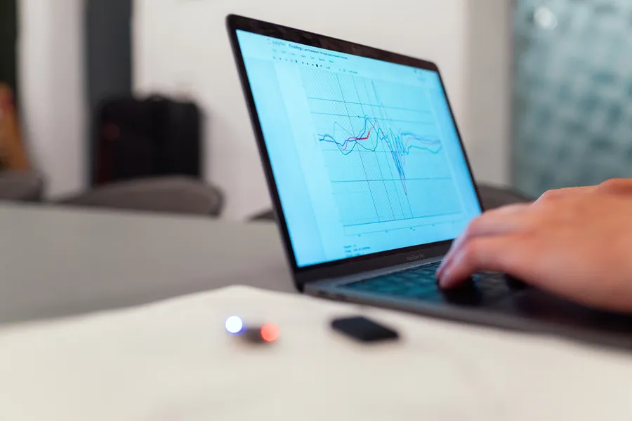 Laptop displaying graphs of data